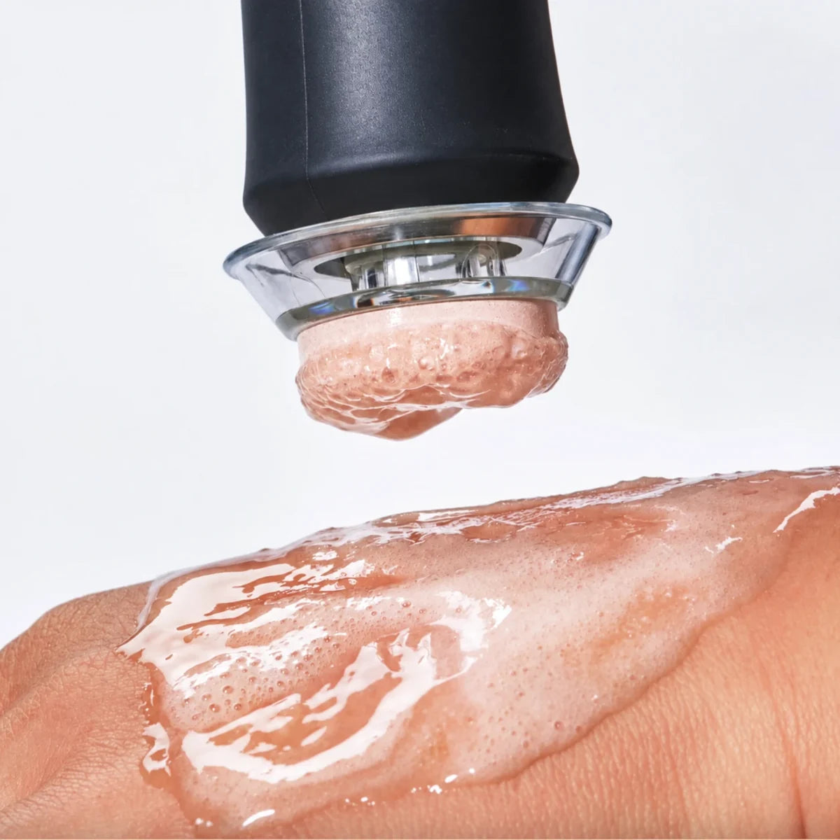 The pen pressing a pink Illuminate pod into gel