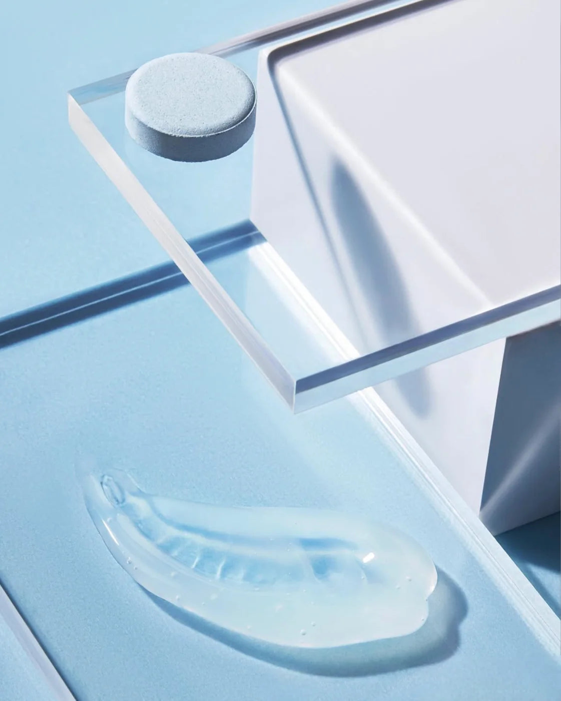 A blue Hydrate pod on a clear shelf above a smear of clear gel