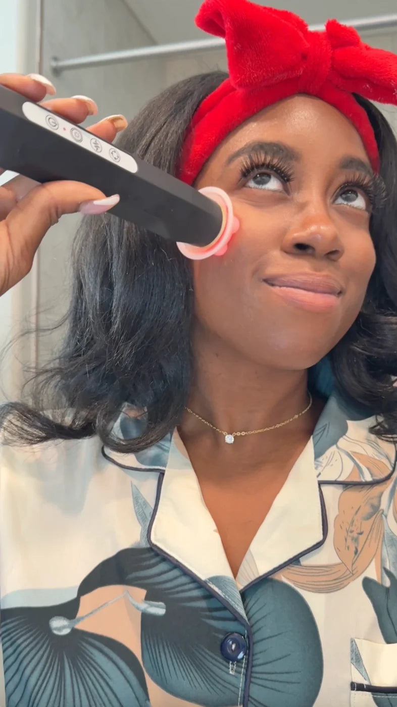 A woman using The Facial Pen on her cheek
