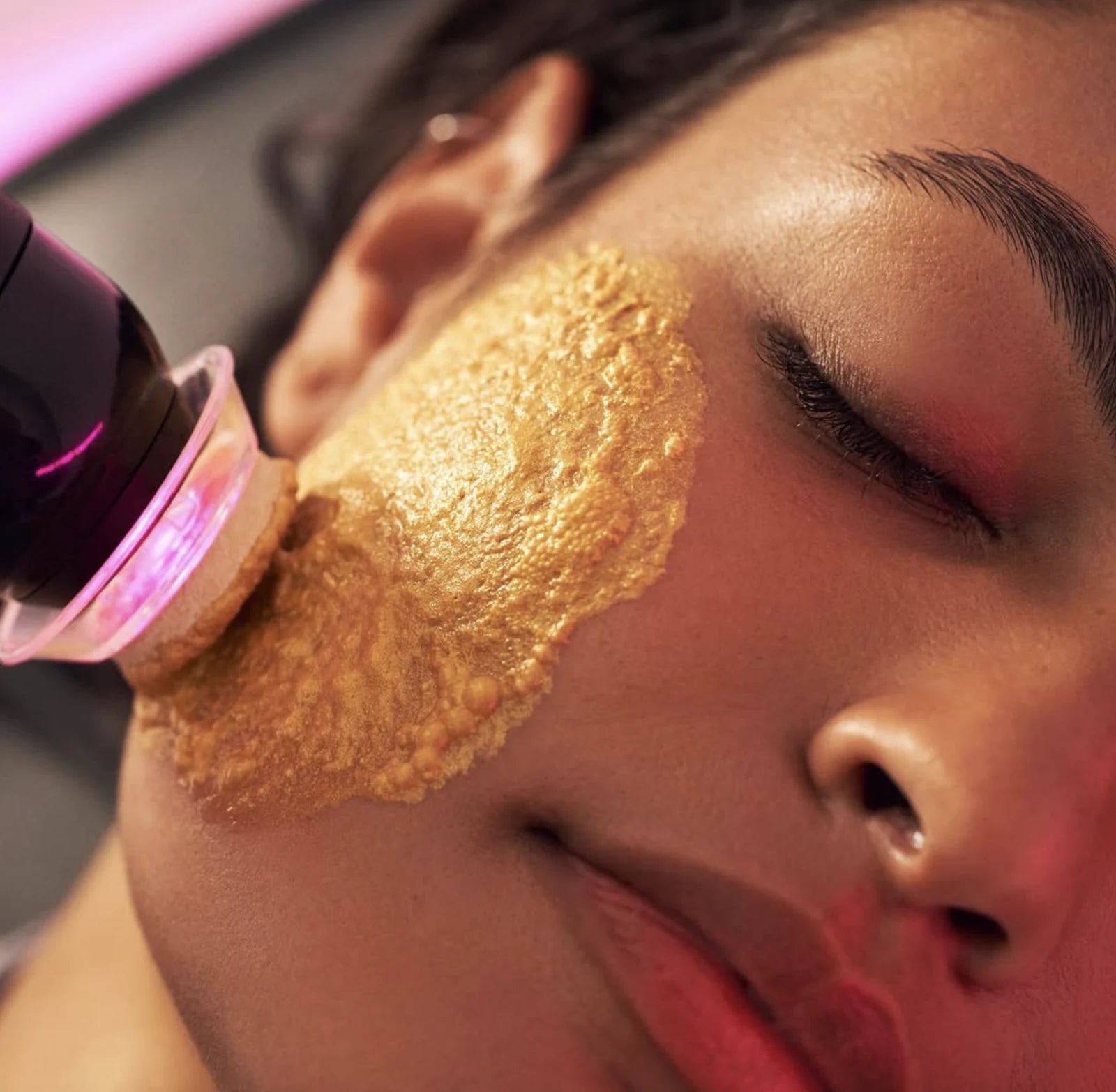 The Facial Pen gliding over a cheek